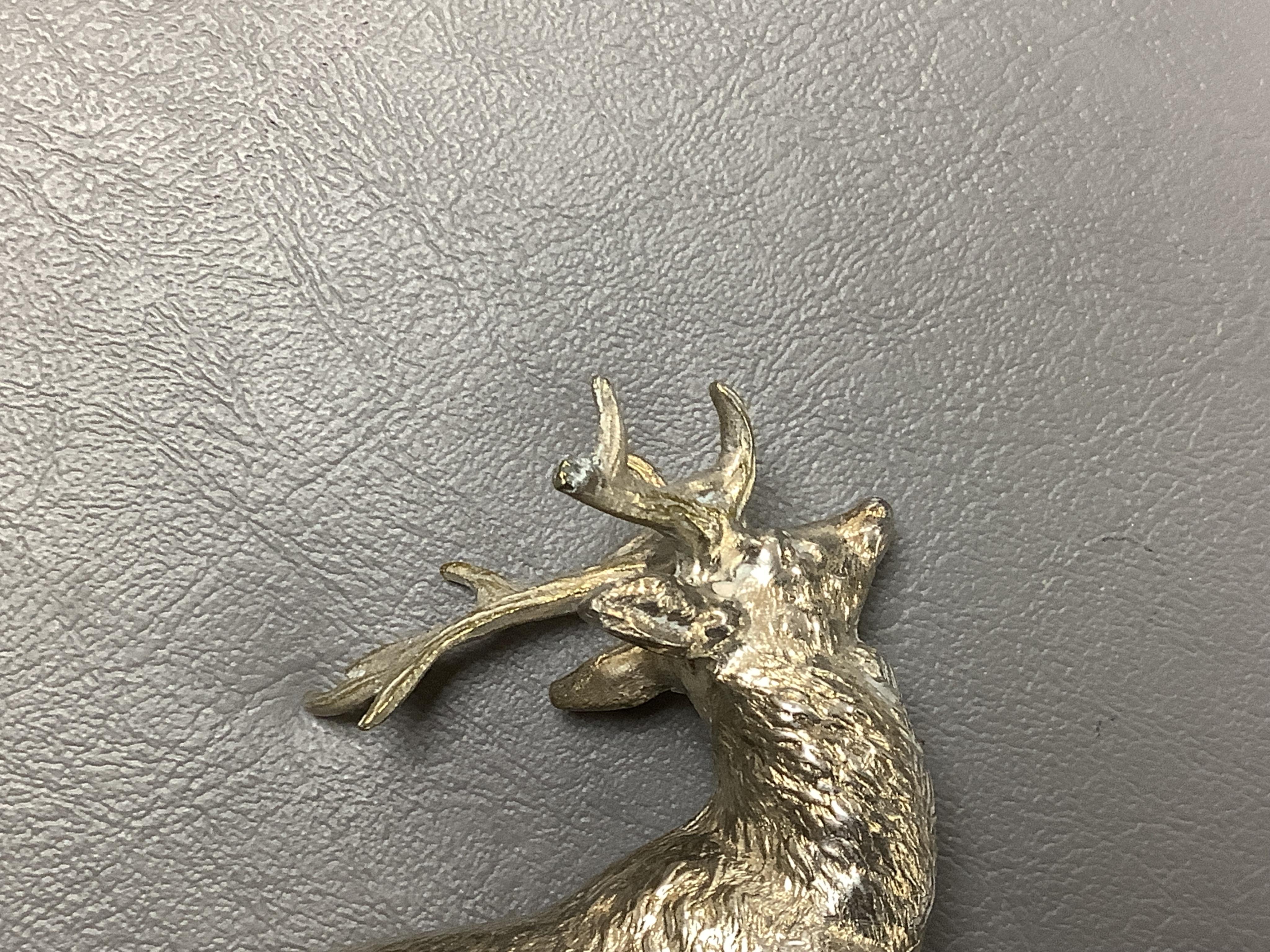 Five chrome and brass car radiator mascots; three in the form of stags’ heads, a stag standing on an oak branch and an Art Deco leading gazelle. Condition - fair, some losses to chrome plating.